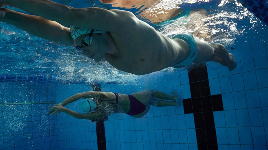 two professional swimmers under water just as they pushed themselves into the next lap.